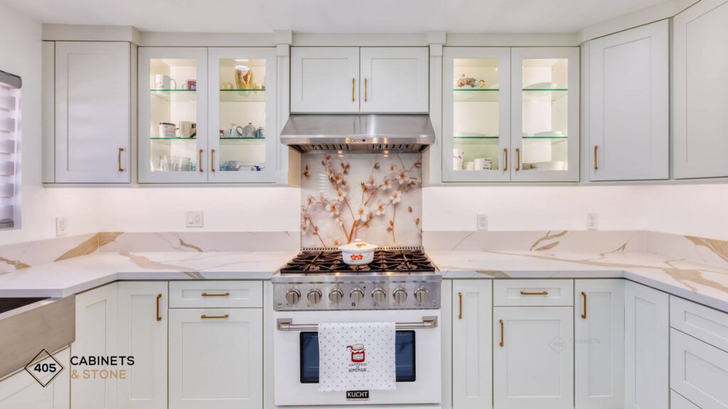 White Shaker kitchen with marble countertops and glass-front upper cabinets