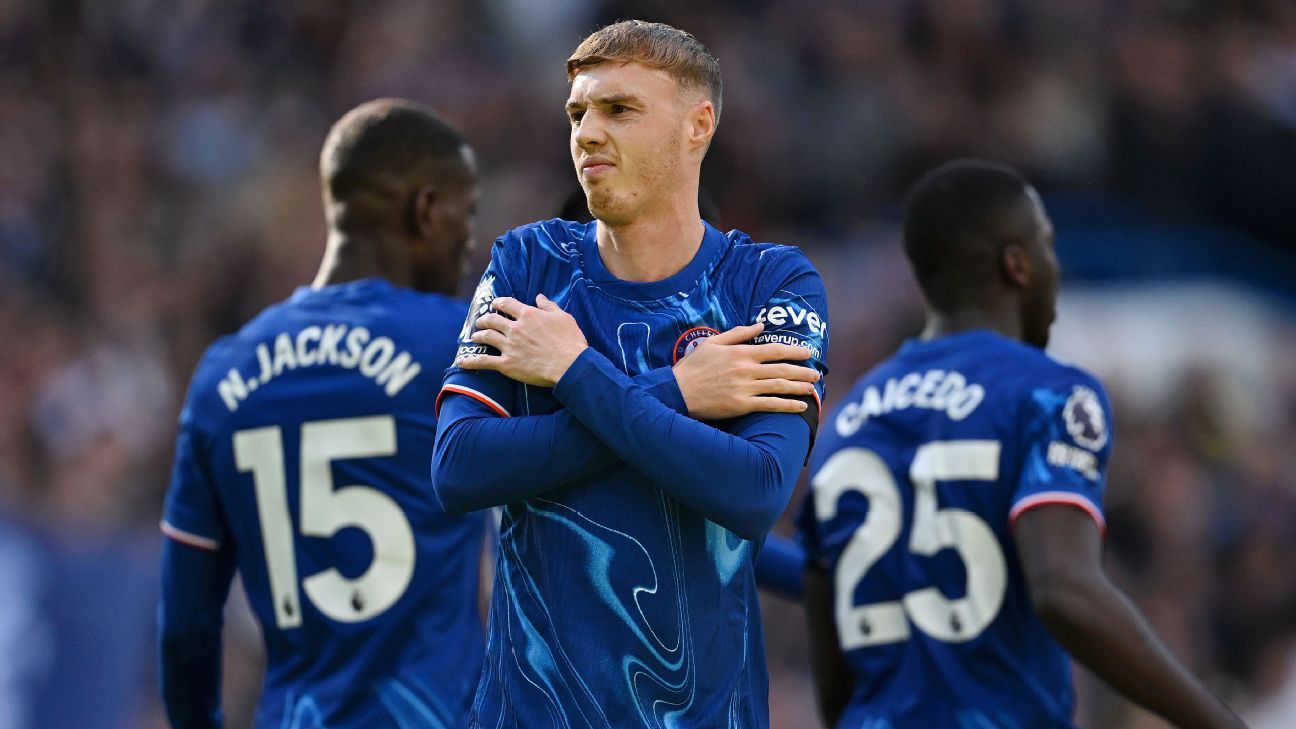 Cole Palmer celebrating goal for Chelsea with arms crossed