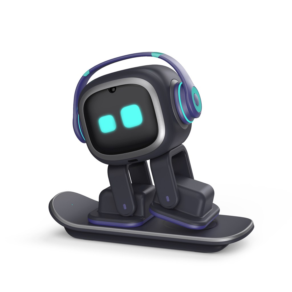 EMO desktop AI companion robot with expressive eyes interacting with human