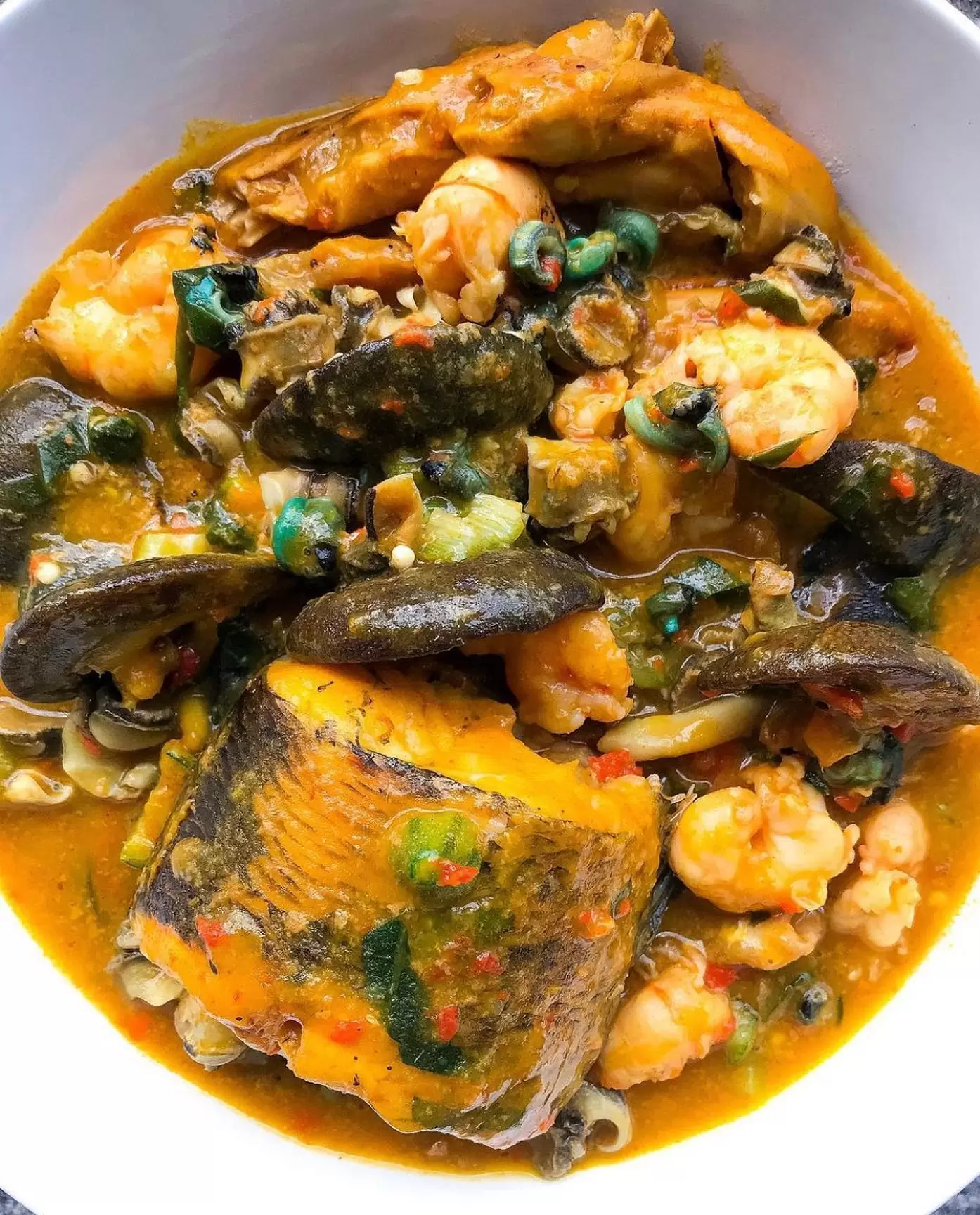 Fisherman soup made with fresh catfish, tiger prawns, periwinkle, crab, scotch bonnet, uziza leaves, crayfish and red palm oil - RoyalRoom Restaurant Lagos
