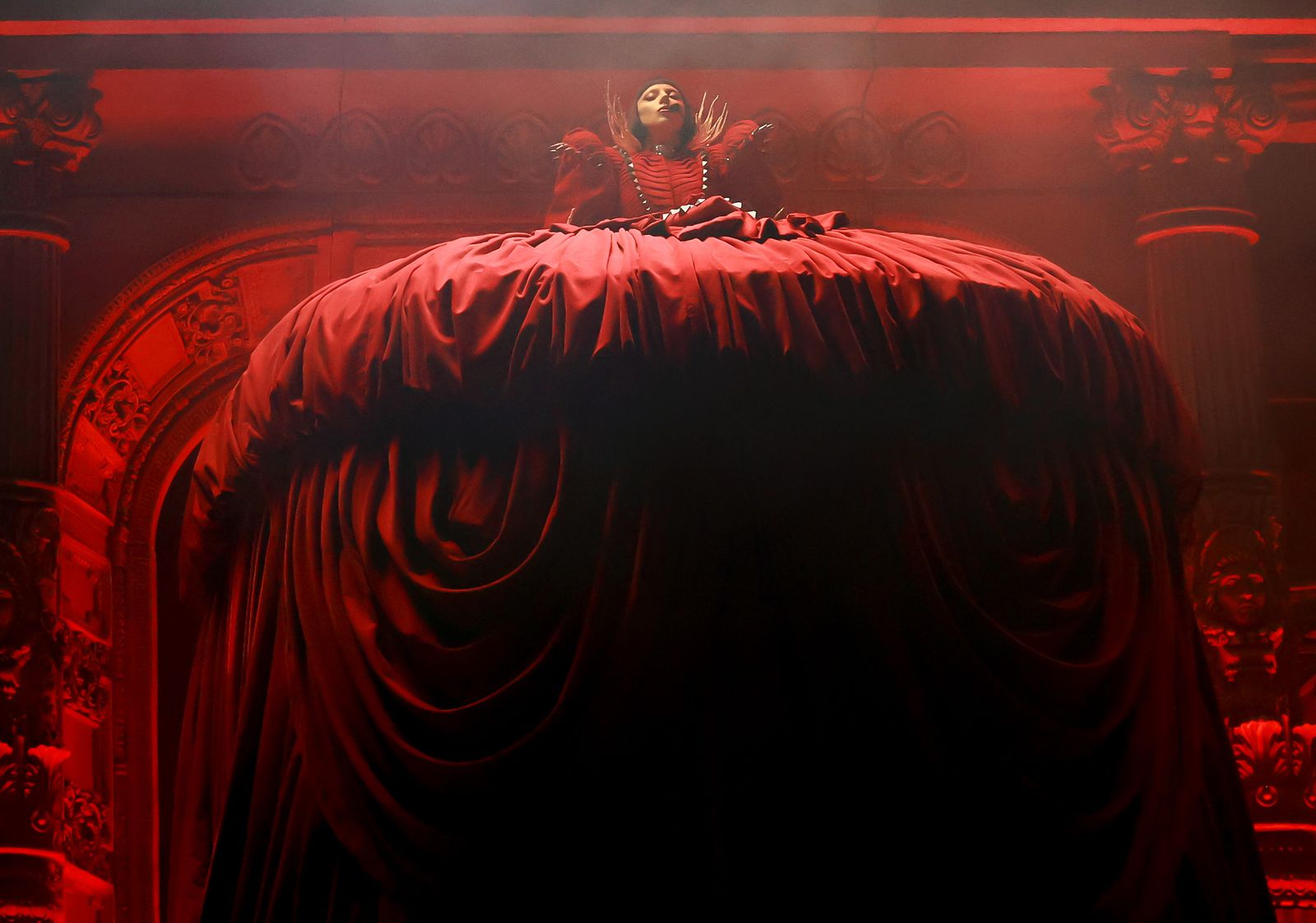 Lady Gaga performing at Coachella 2025 with gothic architecture stage design