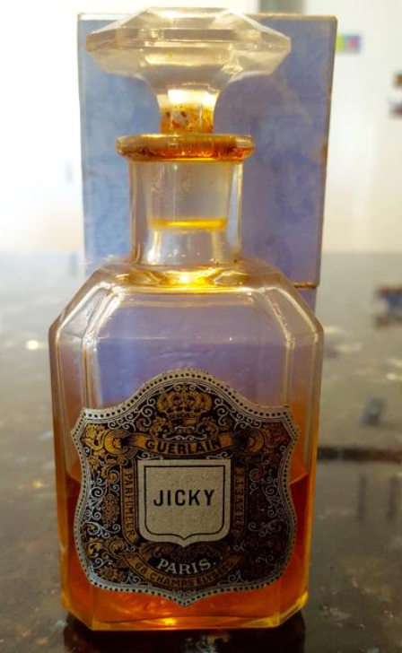 Vintage Guerlain Jicky perfume bottle with ornate label and crystal stopper