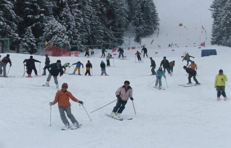 Naltar Valley Ski Tour winter with people skiing on snow slope
