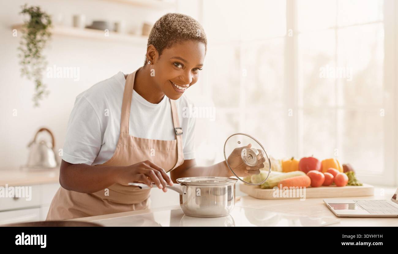 Woman cooking healthy meal with fresh vegetables in bright kitchen