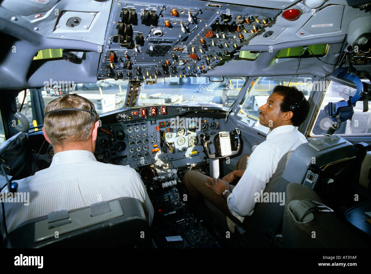 Pilot and co-pilot in the cockpit of a DC-10 commercial airplane Stock Photo - Alamy