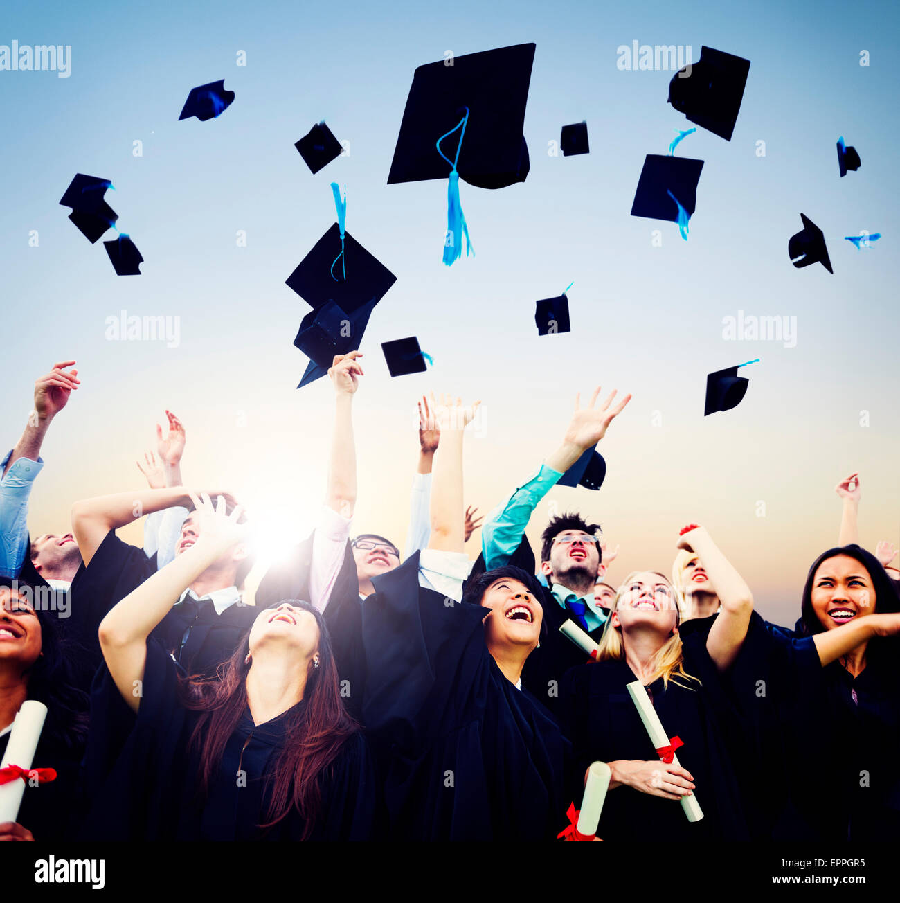 Graduates celebrating throwing caps in the air