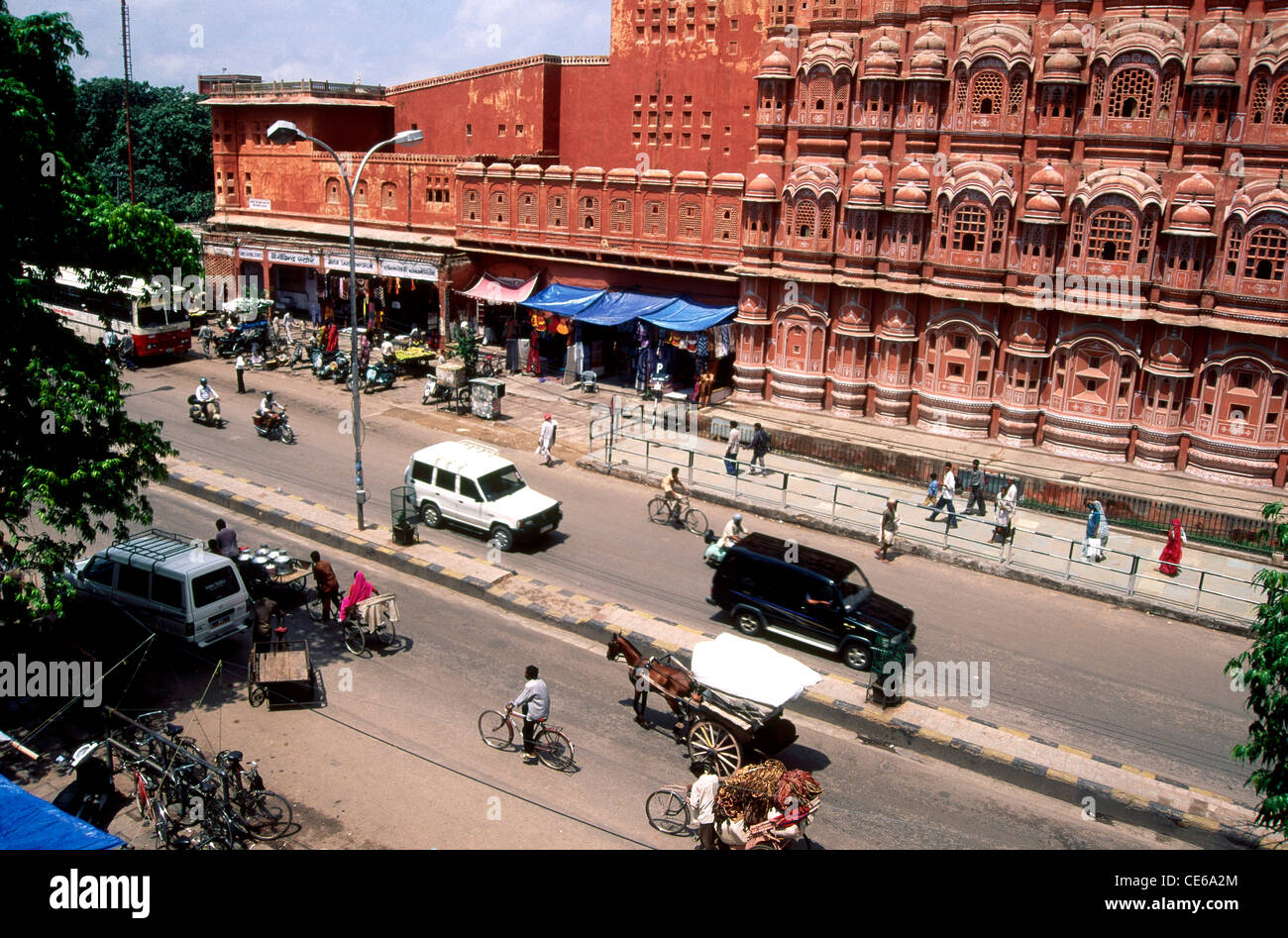Hawa Mahal street view with traffic and local shops in Jaipur