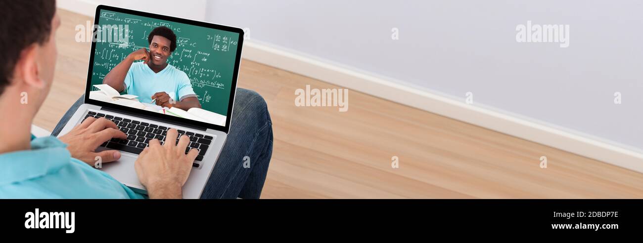 Student learning math online through video conference with tutor on laptop