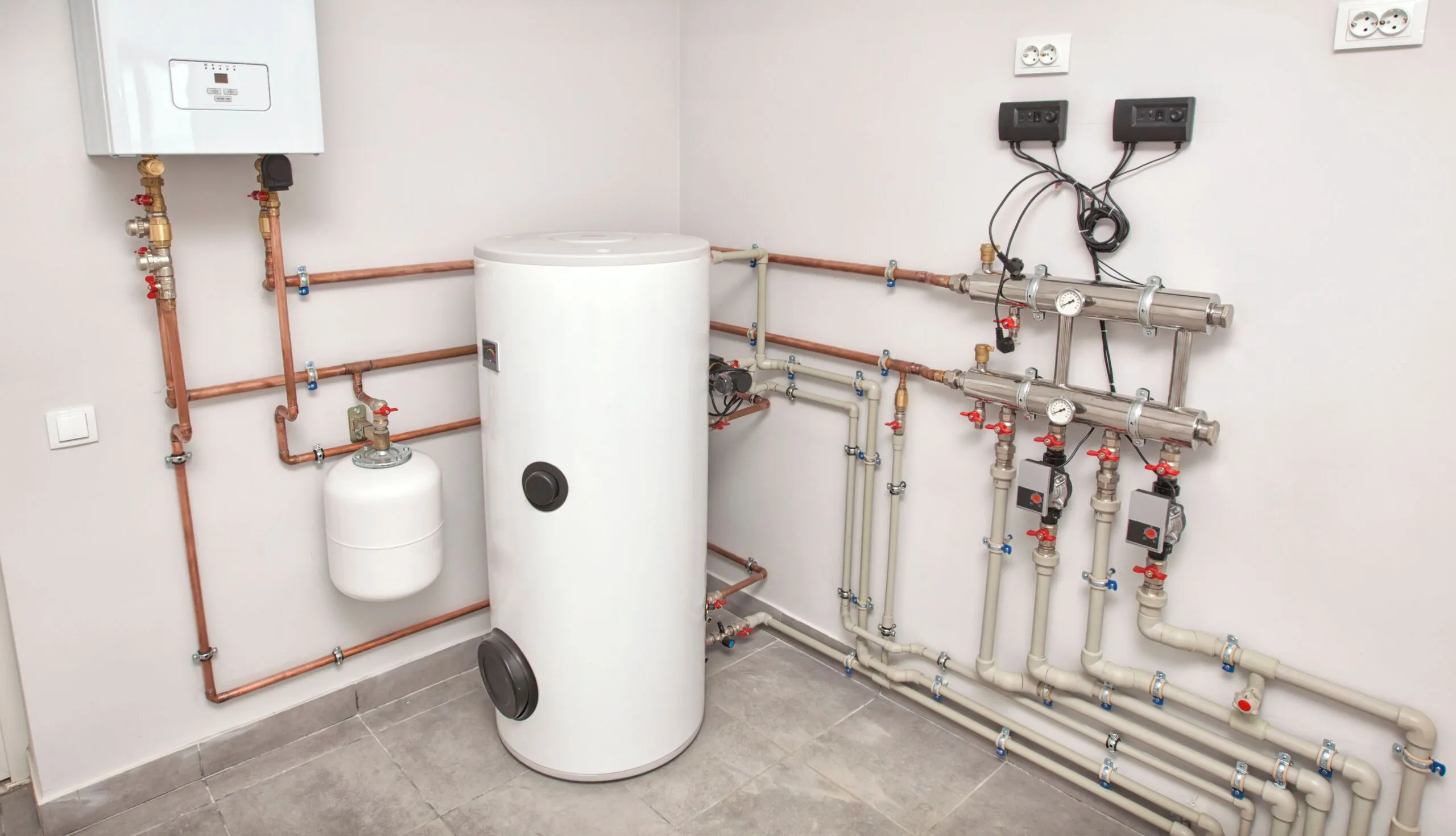 Electric water heater tank with copper pipes installed in home