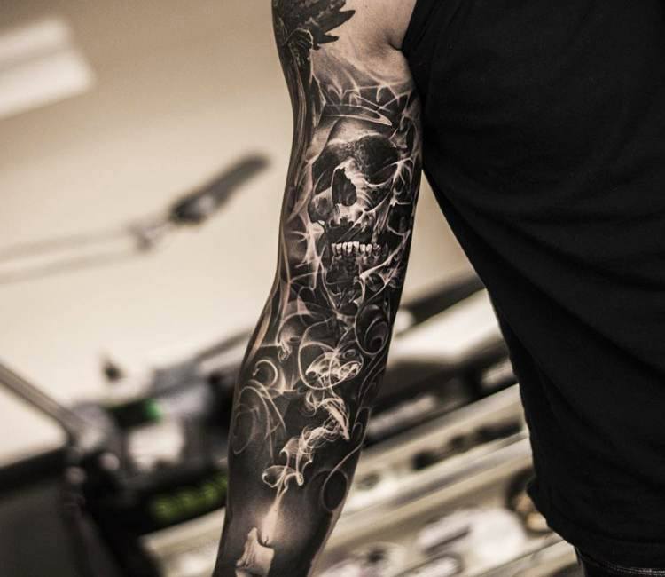 Black and grey skull sleeve tattoo