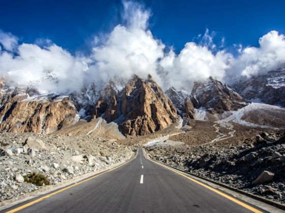 Karakoram Highway road trip tour with mountain road and clouds