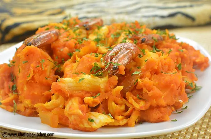 Yam porridge asaro made with white yam, red palm oil, smoked fish, crayfish, scotch bonnet, onions and leafy greens - RoyalRoom Restaurant Lagos