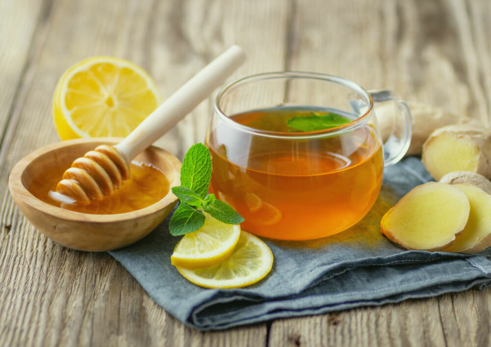 Natural honey lemon ginger tea for family wellness Warm honey lemon tea with fresh ginger and mint for natural wellness