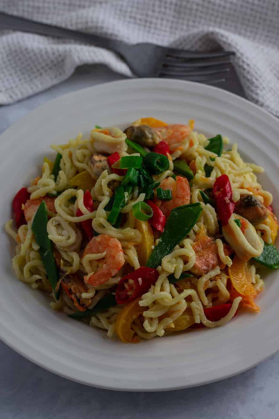 Native noodles made with indomie, red palm oil, crayfish, smoked fish, ugwu leaves and scotch bonnet pepper - RoyalRoom Restaurant Lagos