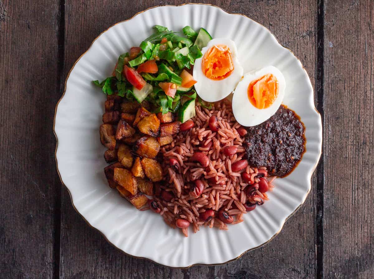 Rice and beans made with brown beans, long grain rice, red palm oil, crayfish, onions, scotch bonnet and seasoning cubes - RoyalRoom Restaurant Lagos