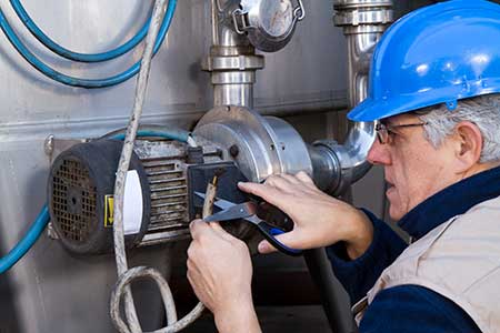 Technician repairing a water pump motor