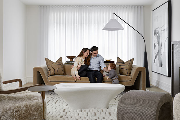 Harry M. and his family relaxing in their restored living room after water damage repair