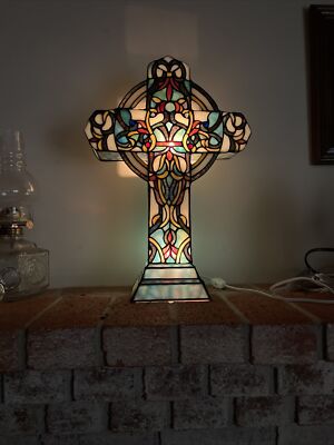 Cross and light rays in stained glass window