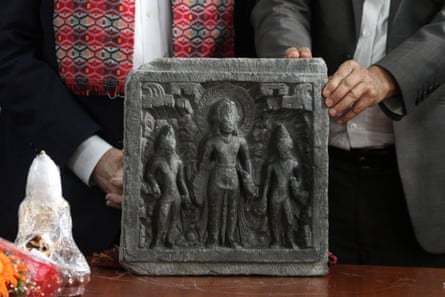 Art experts examining artifact