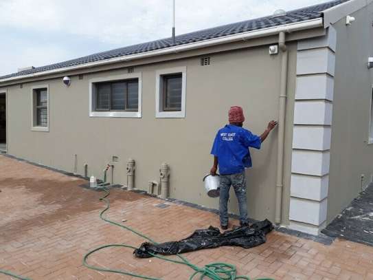 Kenyan painter finishing exterior wall