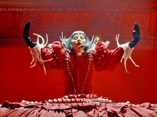 Lady Gaga performing on stage at Coachella 2025 with theatrical lighting