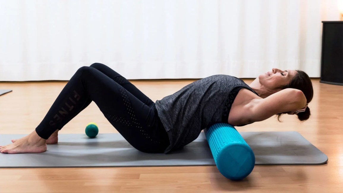 Person using foam roller for back myofascial release