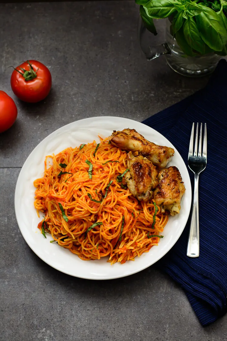 Jollof pasta made with spaghetti, tomatoes, red bell pepper, onions, chicken stock, curry and thyme - RoyalRoom Restaurant Lagos