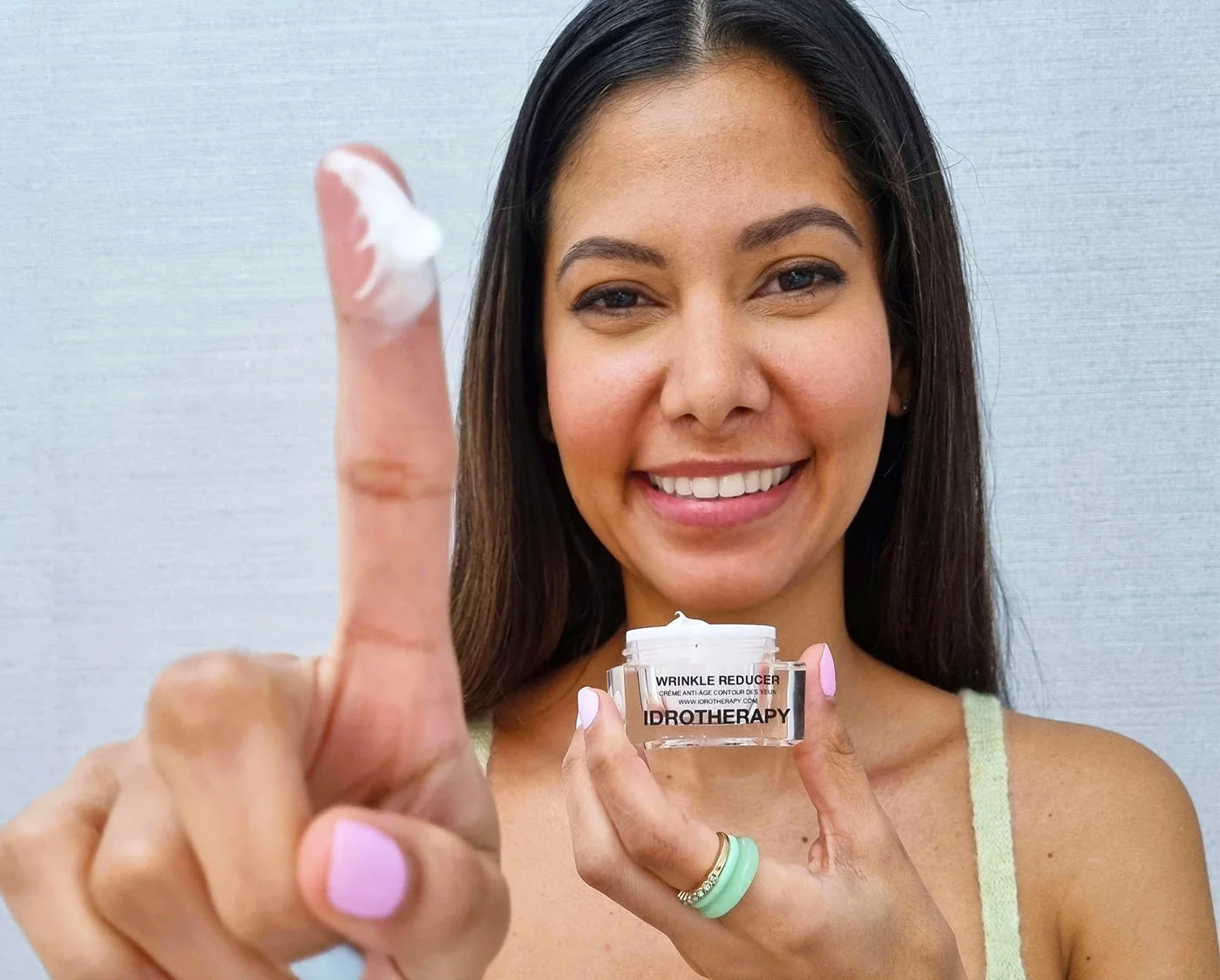 Happy woman holding Idrotherapy Cream
