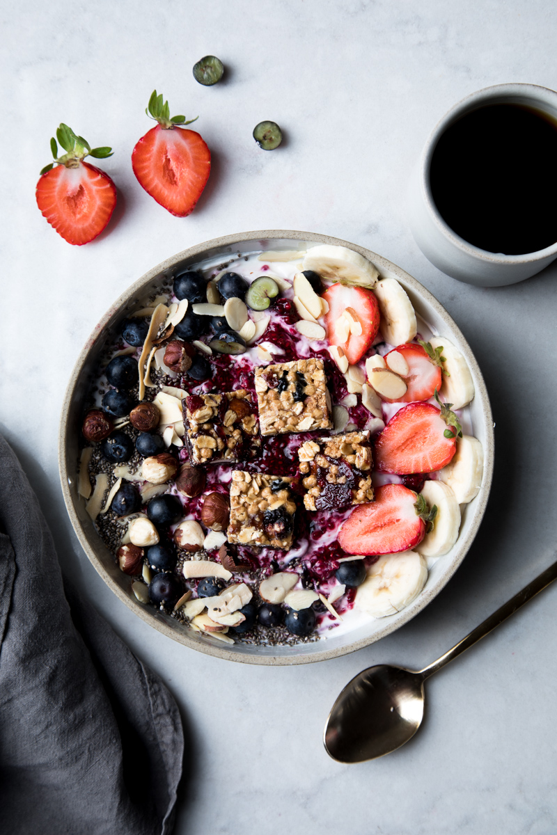 Mixed berry and nut yogurt breakfast bowl with fresh fruits and granola
