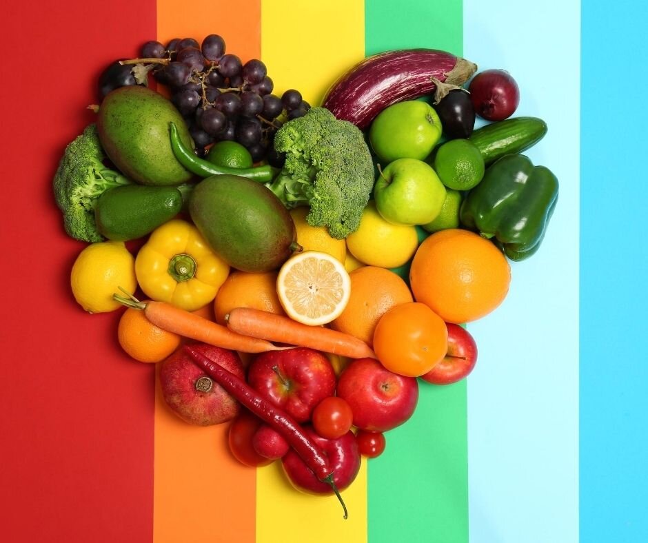 Colorful rainbow of fruits and vegetables arranged in heart shape symbolizing brain and heart health connection