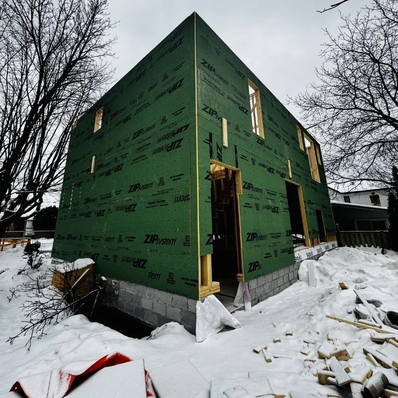 Winter framing construction site in Toronto showing proper weather protection by best framing contractors