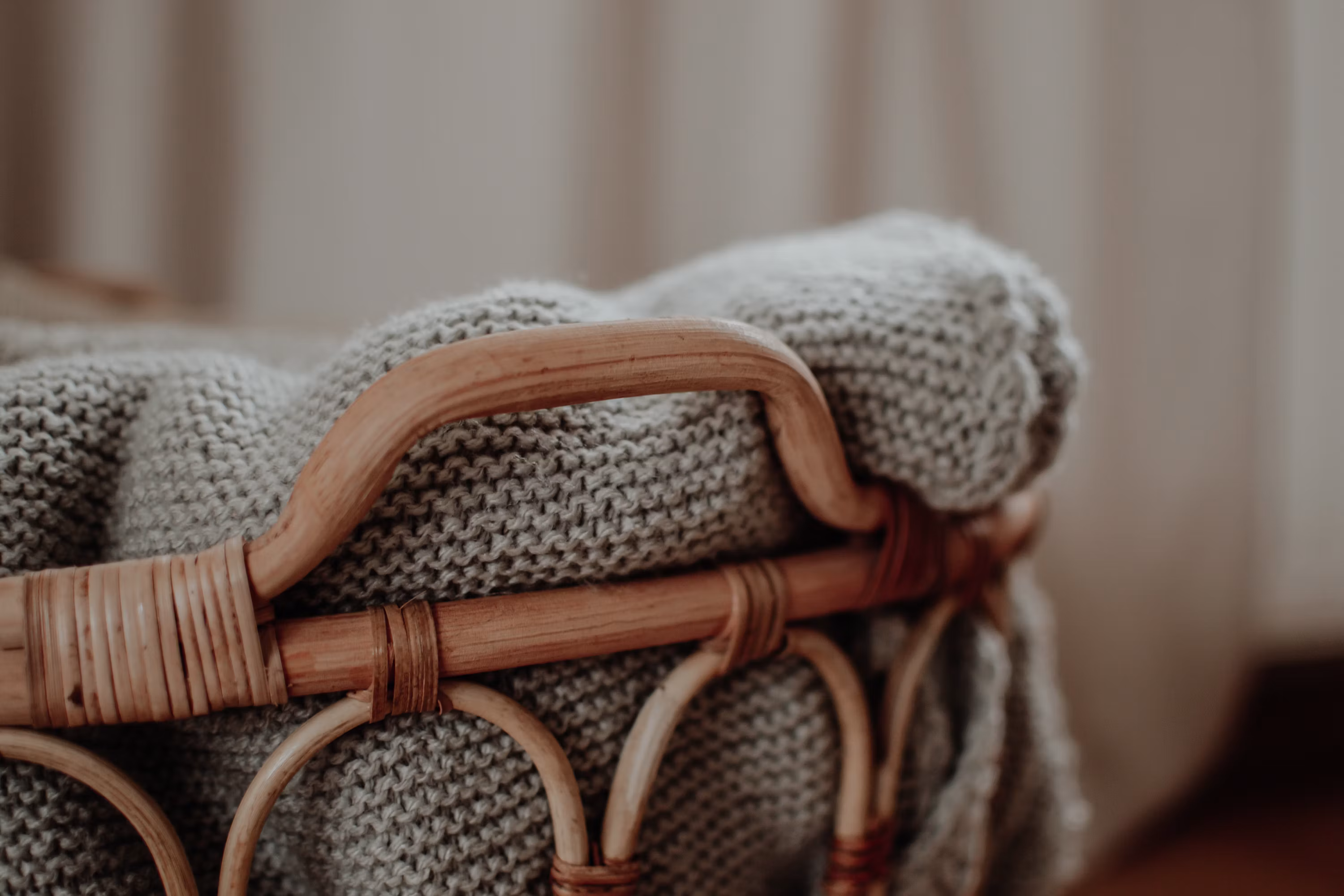 A wicker basket sitting on top of a blanket photo