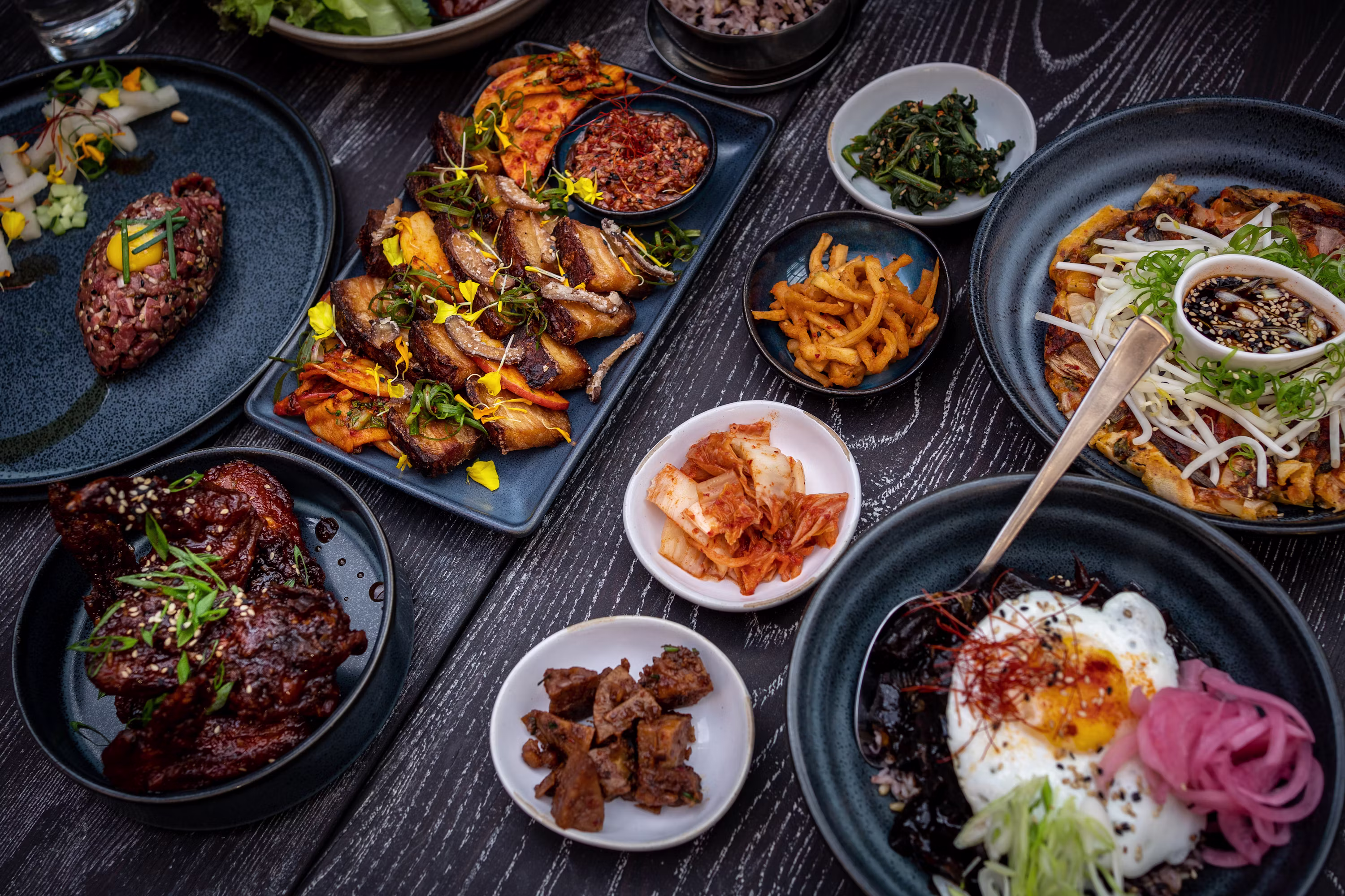 Korean food spread with bibimbap kimchi and various side dishes overhead