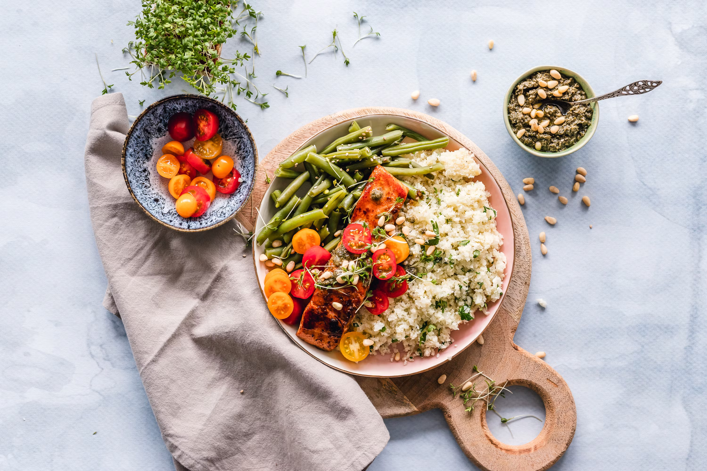 Salmon protein bowl with green beans cauliflower rice tomatoes pine nuts