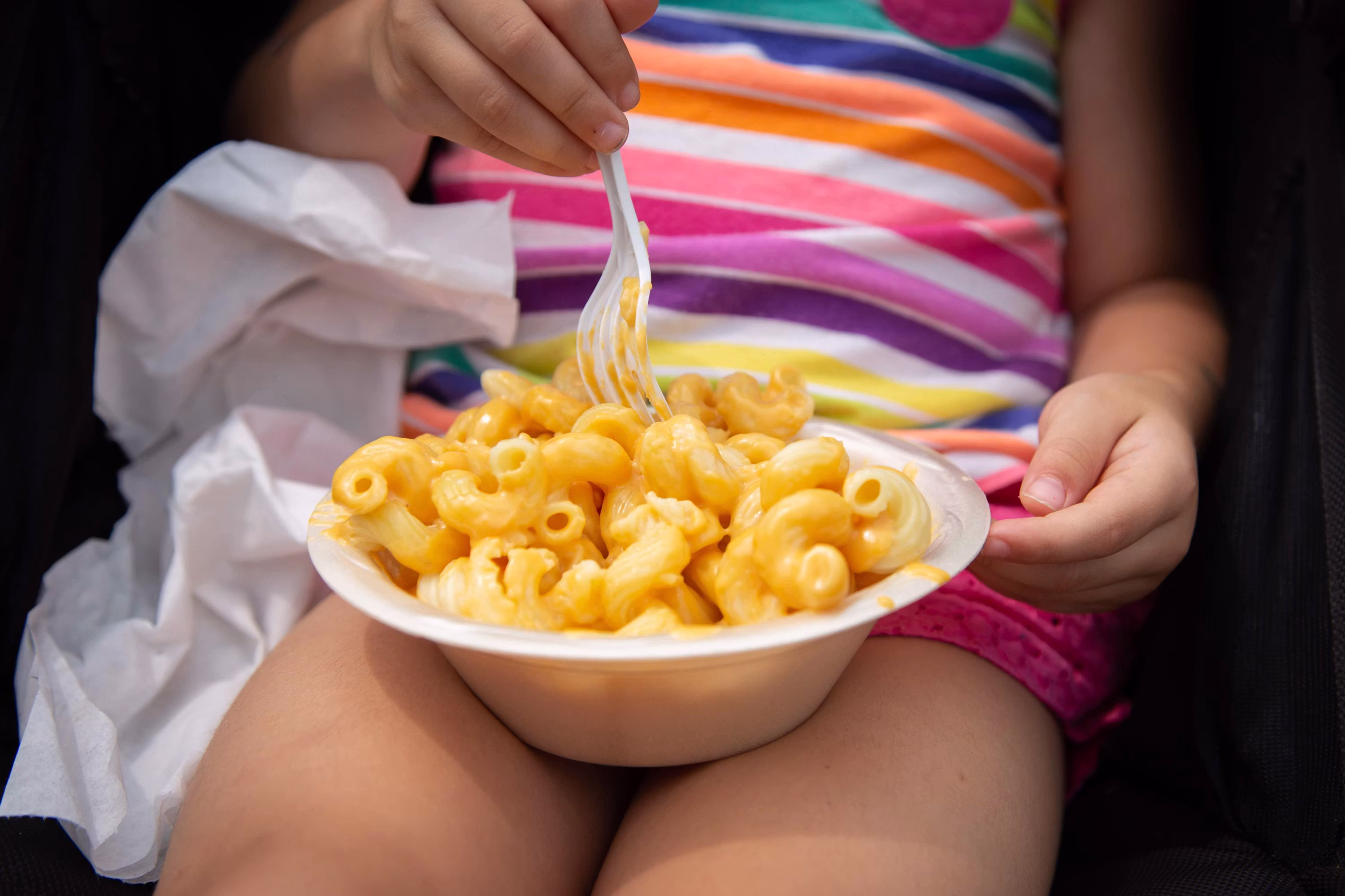Creamy mac and cheese in white bowl with fork