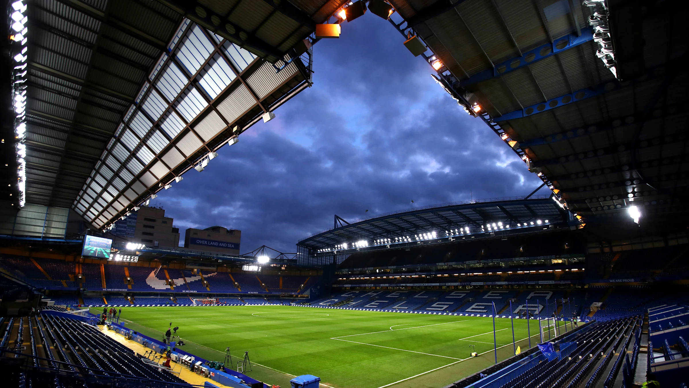 Stamford Bridge stadium under floodlights during night match