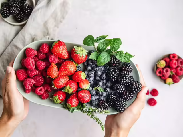 Fresh berries including strawberries raspberries and blackberries in bowl