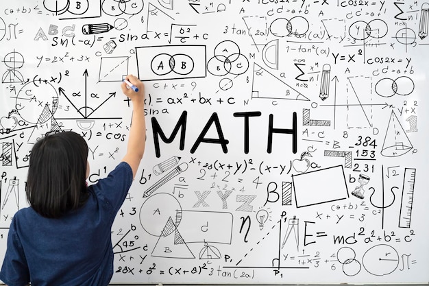 Teacher writing math equations on whiteboard