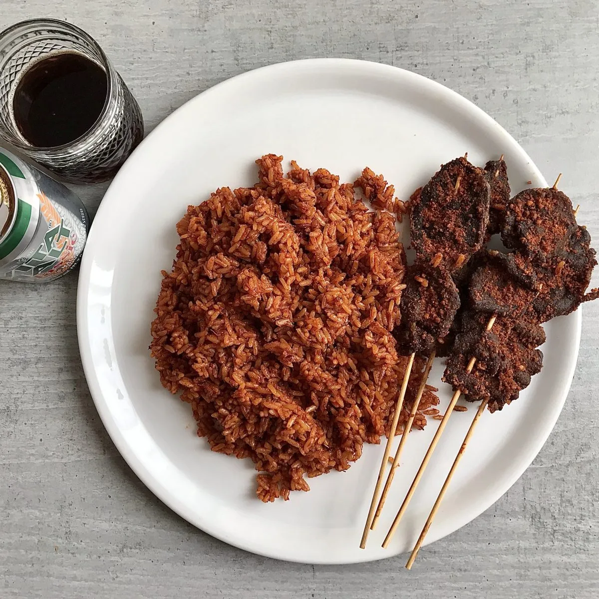 Smoky party jollof rice made with parboiled rice, tomatoes, red bell pepper, onions, chicken stock, bay leaves and smoked over firewood - RoyalRoom Restaurant Lagos