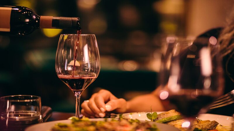Steak wine pairing at Wine and Bottle Nairobi - red wine being poured at fine dining table