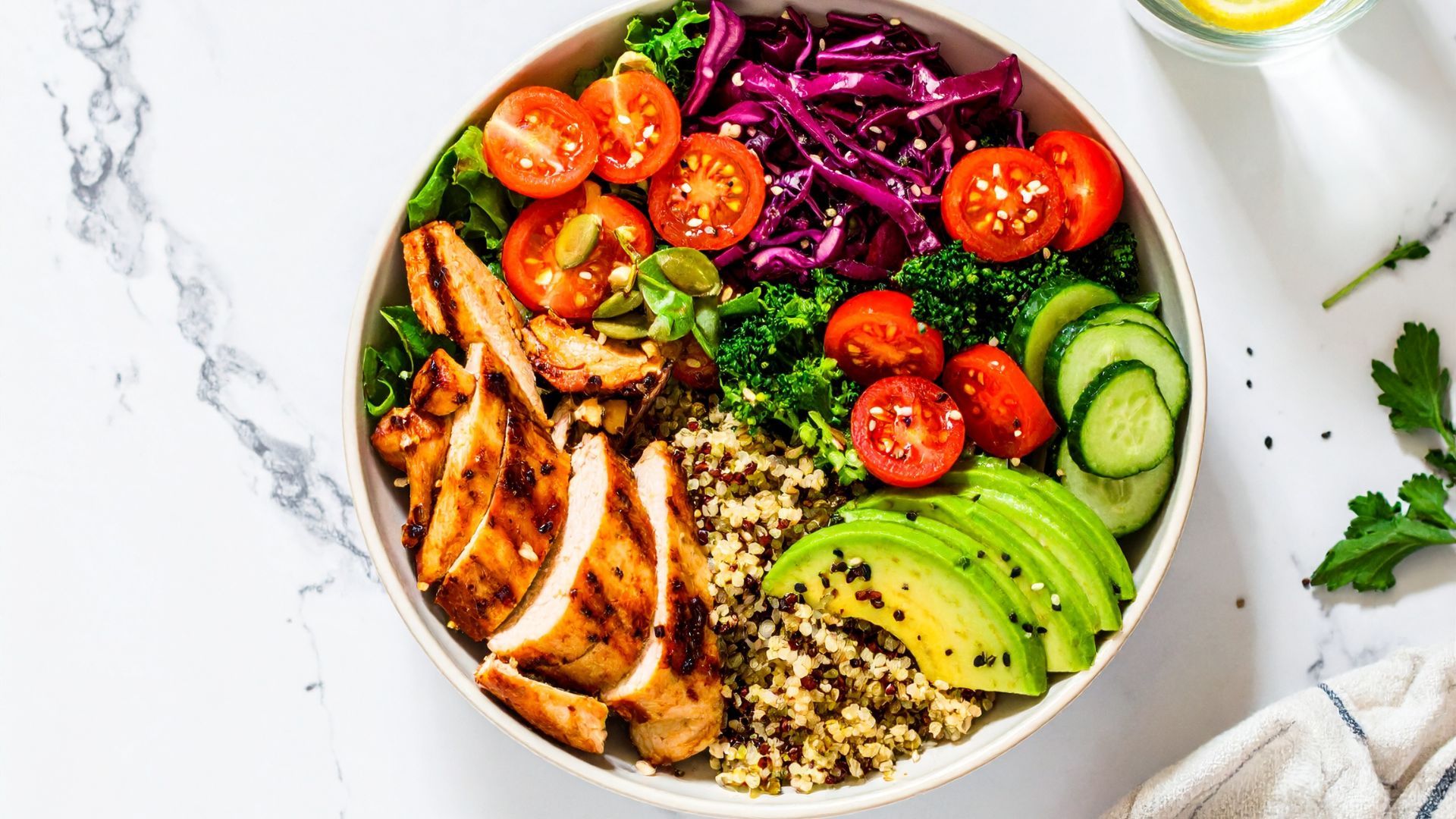 Balanced healthy meal bowl with protein grains and vegetables Colorful balanced nutrition bowl with grilled chicken quinoa avocado and vegetables