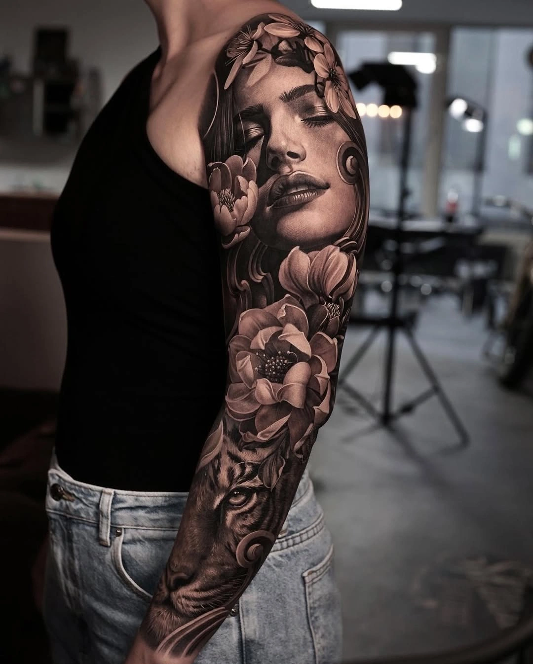 Portrait and flower sleeve tattoo