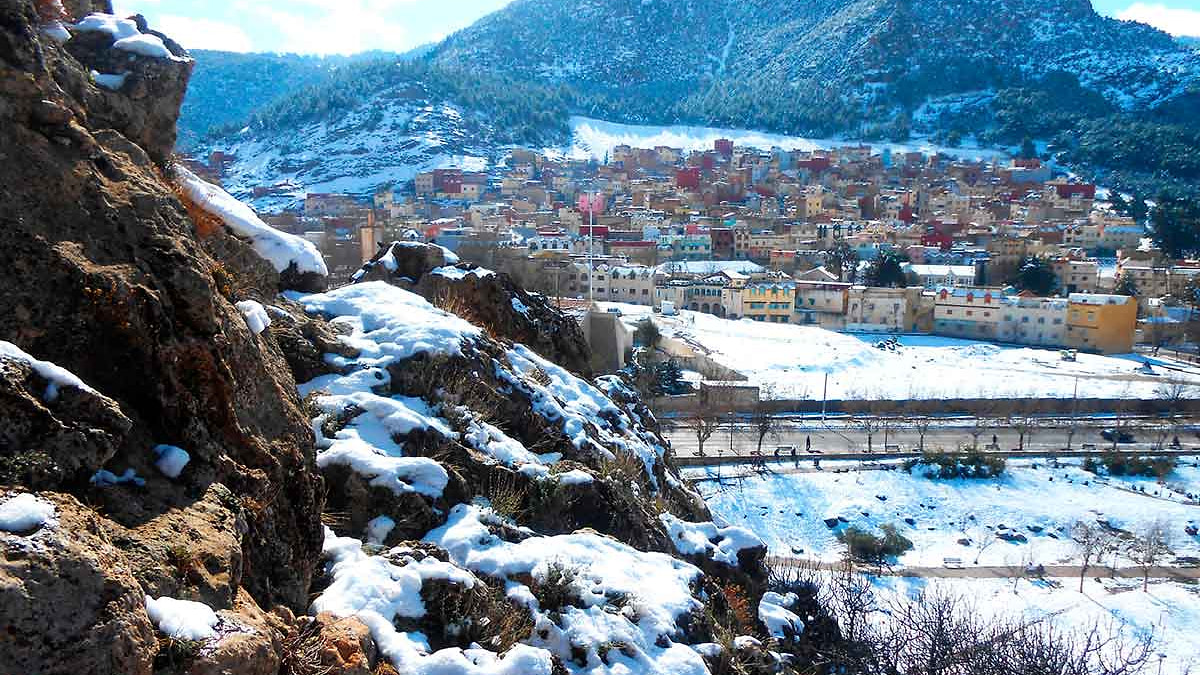 Vue panoramique d'Azrou sous la neige avec la forêt de cèdres en arrière-plan