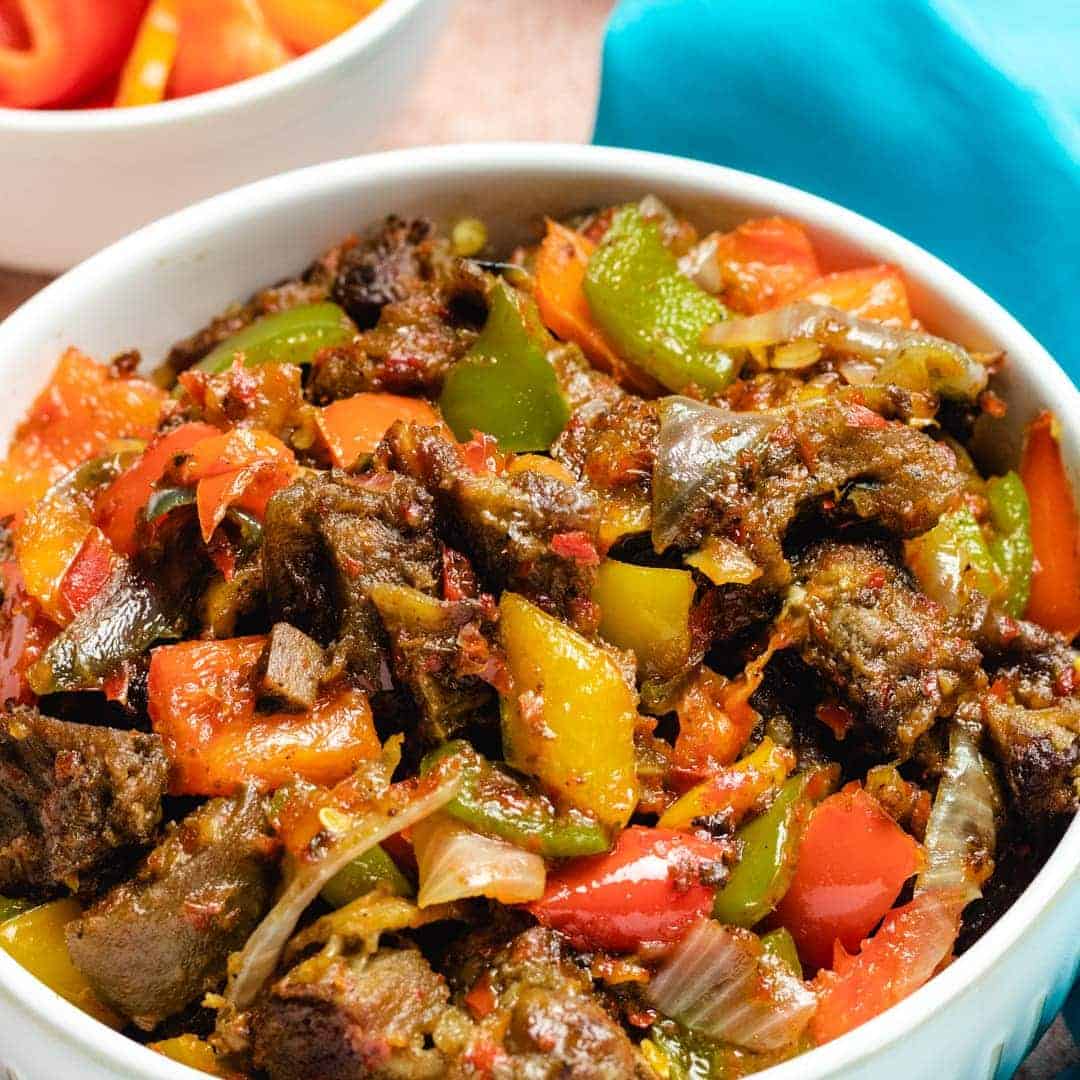Peppered goat meat asun made with goat meat, scotch bonnet, red bell pepper, onions, vegetable oil and seasoning - RoyalRoom Restaurant Lagos