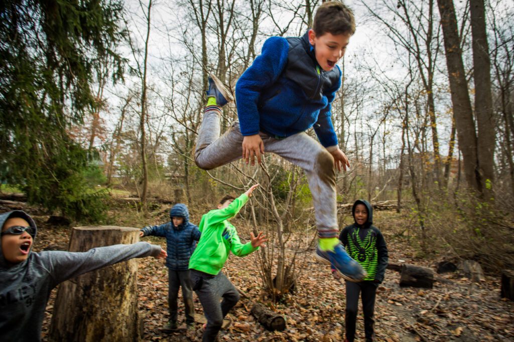 Kids jumping in woods