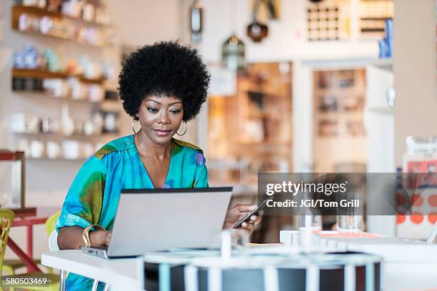 African business owner building website on laptop