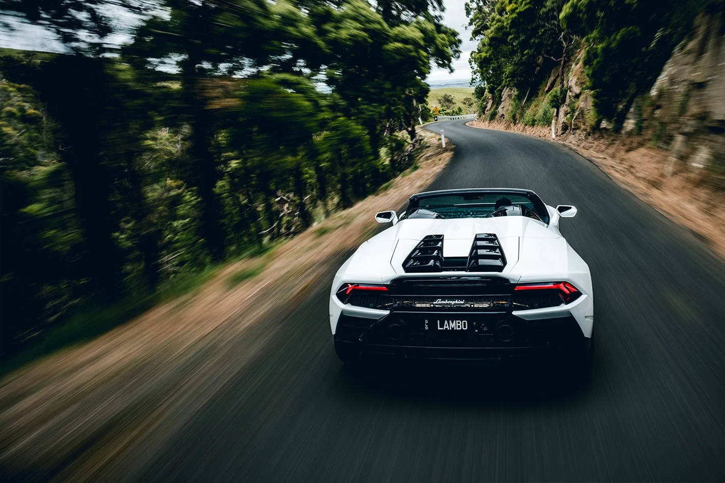 Lamborghini Huracan performing high-speed dynamic cornering on a mountain road