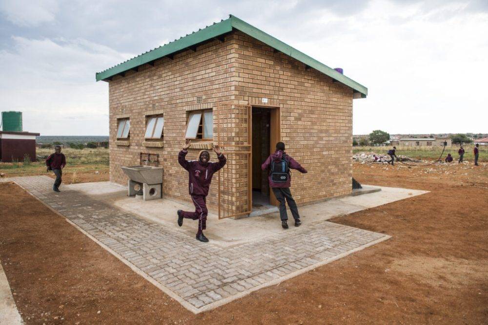 Clean brick school latrine with handwashing station
