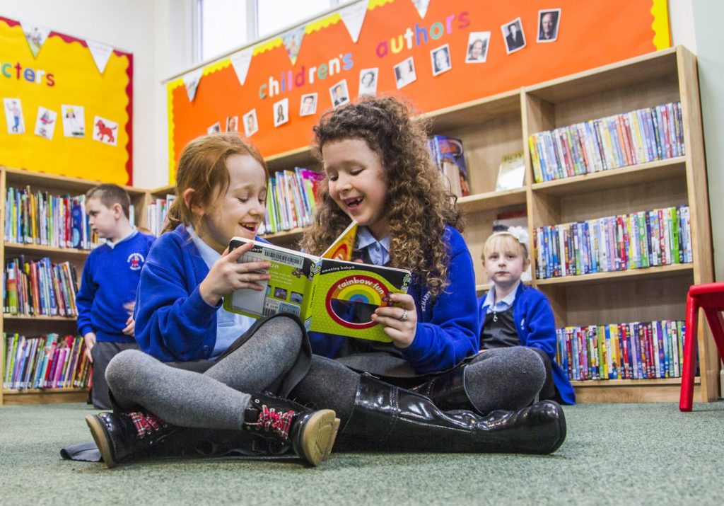 Children reading together in a Welsh school library