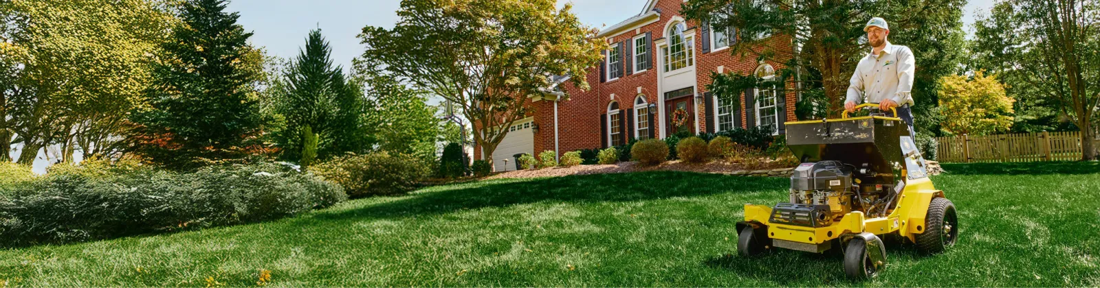 Professional lawn care service mowing a beautiful residential lawn